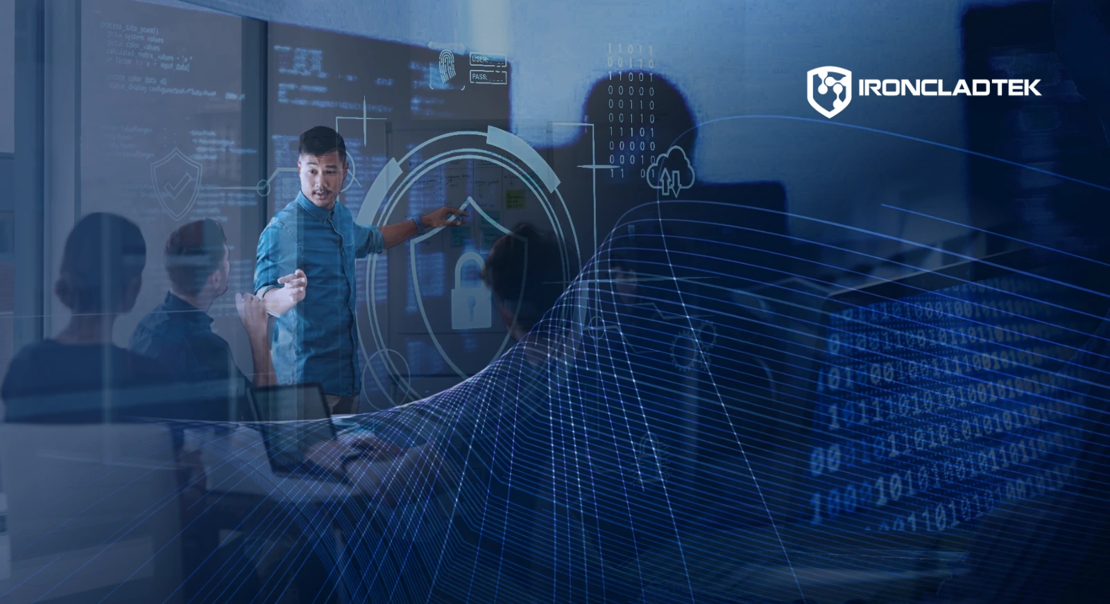 An image that represents the title of the blog, Why Small Businesses Are Bigger Cybersecurity Targets Than They Think. A man stands in front of a large digital screen, with graphics like code superimposed on screen to represent digital threat.